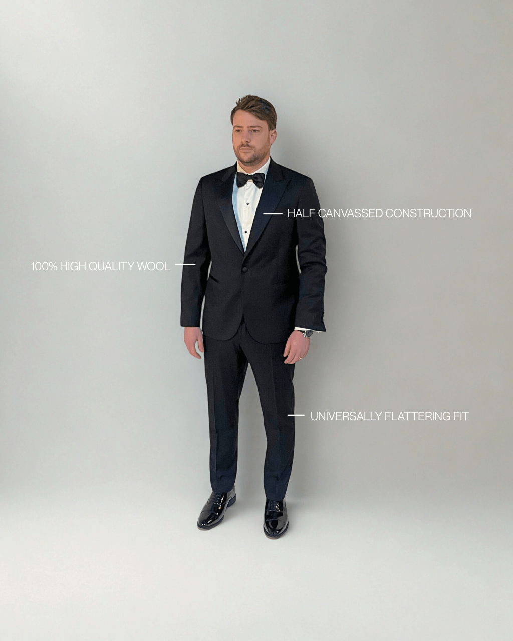 Man wearing a black tuxedo with white shirt and black bow tie on a gray background